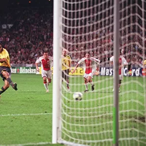Robert Pires shoots past Ajax goalkeeper Hans Vonk to score the 2nd Arsenal goal from the penalty sp