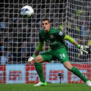 Vito Mannone: Arsenal's Determined Goalkeeper in Action Against Norwich City (2012-13)