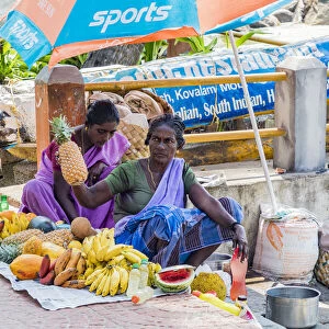 A lady selling fruit at the resort of Kovalam in Kerala, India