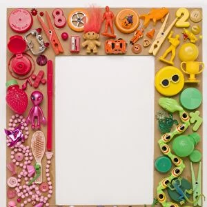 Arrangement of plastic toys and childrens jewellery in frame