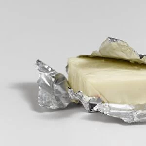 Brazilian Polenguinho cheese partially wrapped in foil