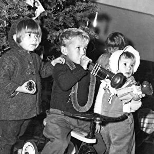 Three children celebrating Christmas