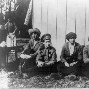 Children of Nicholas II, left to right: Olga, Alexis, Anastasia and Tatiana, seated