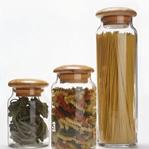 Three clear jars containing dried pasta