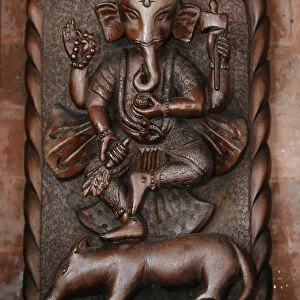 Elephant-headed Hindu god Ganesh straddling a rat