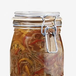 Glass jar of orange and red onion and pepper pickle
