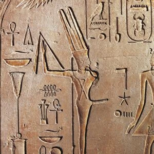 Detail of god Min from a carved stele representing Pharaoh Thutmose III adoring the ithyphallic God Min crowned by a modius and two feathers, limestone