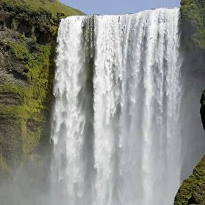 Iceland, Skogafoss (Forest Falls) visitors watching large, powerful waterfall