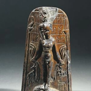 Magic stele portraying infant Horus standing on crocodiles and holding animals in his hands and surrounded by spell books. It was used in the practice of magic to defend oneself against dangerous animals