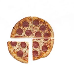 Pepperoni pizza cut into four quarters, one slice slightly removed from the others