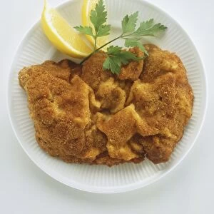 Plate of breaded veal or pork escalopes, Wiener schnitzel, with lemon and parsley leaf