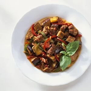 Plate of lamb ratatouille garnished with basil leaves