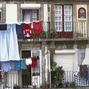 Portugal, Oporto, Barredo, washing hanging from lines on balconies of old houses
