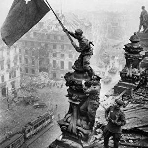 Red army soldiers raising the soviet flag over the reichstag in berlin, germany, april 30, 1945, photo taken by vladimir grebnev