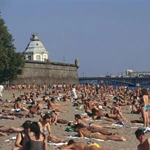 Russia, St Petersburg, the beach outside the Peter and Paul Fortress, full of people sunbathing