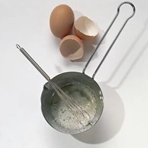 Saucepan, wire whisk, egg and egg shells