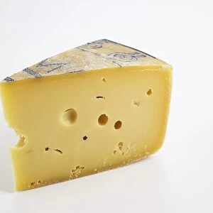 Slice of Italian Formai de Mut dell Alta Val Brembana PDO cows milk cheese