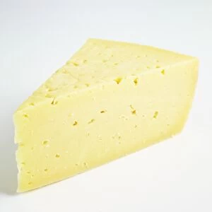 Slice of semi-soft Swedish Prastost cows milk cheese