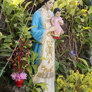 Statue of the Virgin Mary in the garden of a catholic church