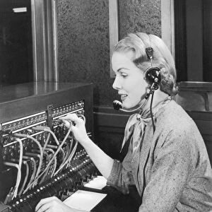Telephone operator working at switchboard