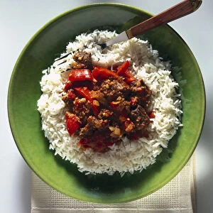 Thai Red Beef Curry, cubes of chuck steak served on dinner plate on bed of boiled white rice