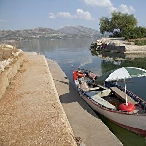 Turkey, Goller Bolgesi (Lakes Region), Lake Egirdir, moored boat with sun umbrella at lakeshore