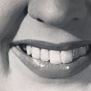 United States: c. 1960. A closeup of a smiling womans mouth