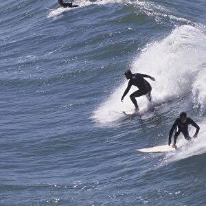 USA, California, Huntington Beach, two surfers riding waves
