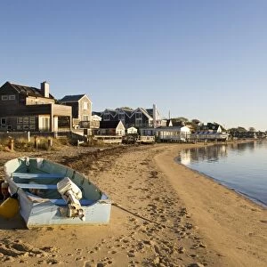 USA, Massachusetts, Cape Cod, Provincetown, small fishing boat on beach lined with houses