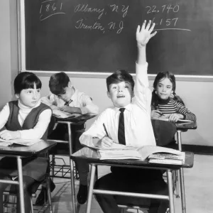 Vintage image of boy raising hand in classroom