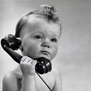 Vintage photo of baby boy talking on phone