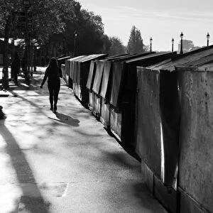 Walking by stalls on the Seine Embankment at sunset