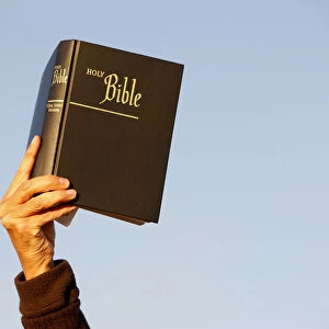 Woman holding up a Bible