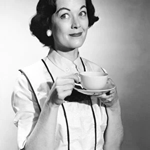 Women in apron enjoying a cup of tea