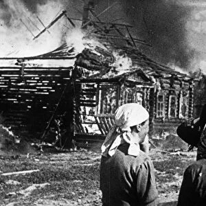 World war 2, soviet women watch as their homes burn with fire set by retreating germans