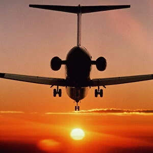 Boeing MD-80 airliner landing at sunset