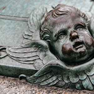 Cherubs face on a grave of Augustin EhrensvAÔé¼rd at Suomenlinna, Finland