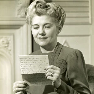 Mature woman reading letter