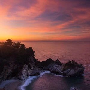 Mcway falls at sunrise over pacific ocean