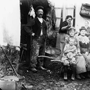 Parents, children (7-16) and mature women in front of farm house (B&W)