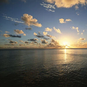 Scenic View of the Sun Setting over the Calm Ocean