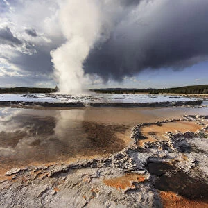 Stormy clouds over Great Fountain Geyser, Yellowstone National Park, Wyoming, USA