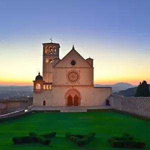 The sun sets behind St. Francis Basilica in Assisi