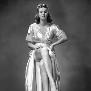 Woman in derssing gown and silk stockings