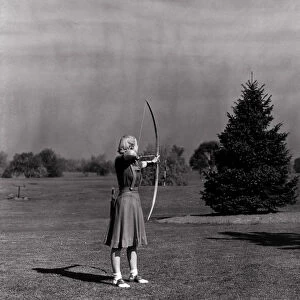 Woman Shooting Arrow at Archery Target