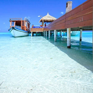 Wooden pier with boat, side view, Maldives