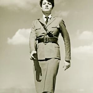 Young woman in military outfit marching on rooftop, portrait