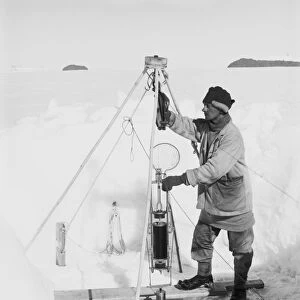 Nelson in his igloo with the Nansen-Petersson insulating water-bottle. December 24th 1911