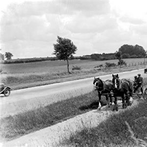Country roads were almosts empty of traffic. Here in 1936 a car passes a horsedrawn mower