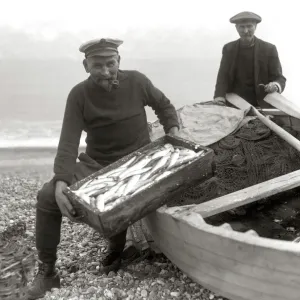 The Coxswain of the Aldeburgh lifeboat, Charlie Mann, with a catch of herrings